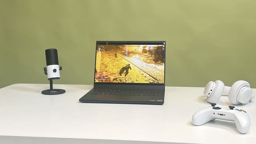 A Razer Blade 14 2025 on a desk playing Helldivers 2